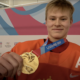 Matvei Michkov holds his gold medal.