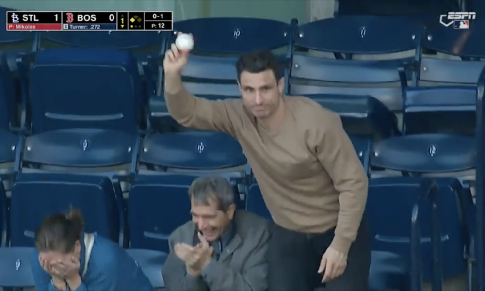 Garnet Hathaway shows off a foul ball he caught at a Boston Red Sox game.