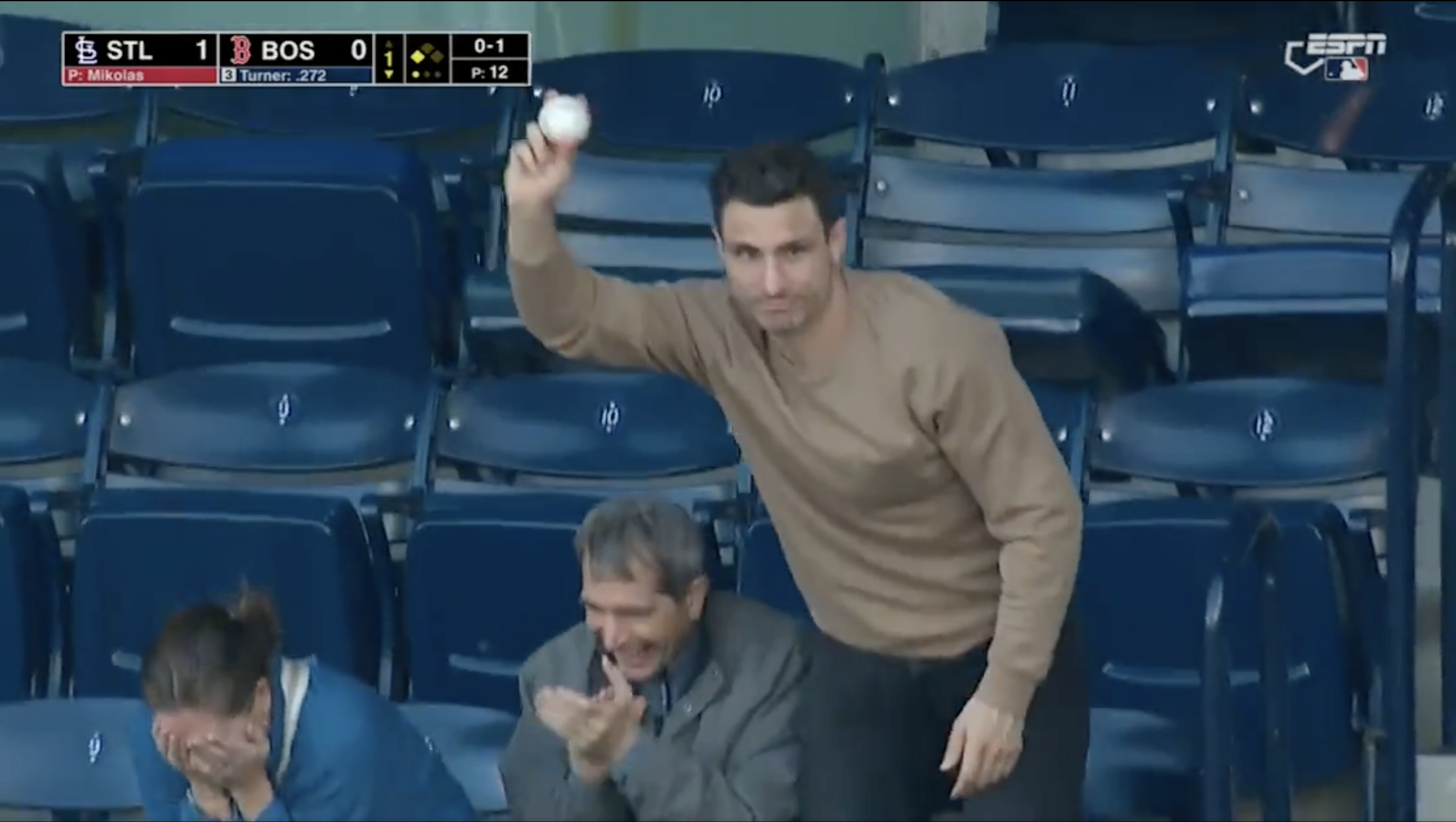 Garnet Hathaway shows off a foul ball he caught at a Boston Red Sox game.
